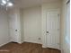 Bedroom featuring wood look flooring, neutral walls, white trim, and standard closet doors at 614 W 7Th Ave, Mesa, AZ 85210