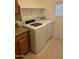 Bright laundry room featuring a new washer and dryer and shelving above at 614 W 7Th Ave, Mesa, AZ 85210