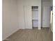 Neutral bedroom with light-toned tile floors and double doors to closet with shelving at 6225 S Boulder St, Gilbert, AZ 85298