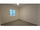 Bright bedroom with neutral walls, tile floors, and a window with plantation shutters at 6225 S Boulder St, Gilbert, AZ 85298