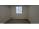 Bright bedroom with neutral walls, tile floors, and a window with plantation shutters at 6225 S Boulder St, Gilbert, AZ 85298