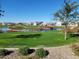 Scenic community park with a picturesque pond, lush green grass, and flowering bushes at 6225 S Boulder St, Gilbert, AZ 85298