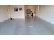 Spacious garage with epoxy flooring, storage shelves, and a water filtration system at 6225 S Boulder St, Gilbert, AZ 85298