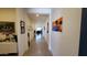 Long hallway with tiled floors, decorative wall art, and modern lighting fixtures at 6225 S Boulder St, Gilbert, AZ 85298