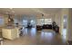 Open-concept living space with a kitchen island, dining area, and plantation shutters at 6225 S Boulder St, Gilbert, AZ 85298