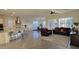 Open-concept living space with a kitchen island, dining area, and plantation shutters at 6225 S Boulder St, Gilbert, AZ 85298