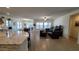 Spacious living room with tile flooring, plantation shutters, and a view into the kitchen at 6225 S Boulder St, Gilbert, AZ 85298