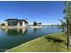 Modern waterfront home with expansive windows, nestled on a serene lake at 6225 S Boulder St, Gilbert, AZ 85298