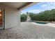 Back patio leading to a private backyard with a pool, lush greenery, and beautiful blue sky at 6993 S Roger Way, Chandler, AZ 85249