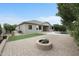 Spacious backyard with a pool, fire pit, grass area, and outdoor living space for entertaining at 6993 S Roger Way, Chandler, AZ 85249