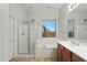 Bathroom featuring a soaking tub, glass enclosed shower, and wood cabinetry at 6993 S Roger Way, Chandler, AZ 85249