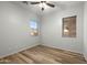 Bedroom with modern ceiling fan, wood-look flooring, and a window with a view of the outdoors at 6993 S Roger Way, Chandler, AZ 85249