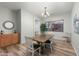 Dining room with a wood table, chandelier, and natural light at 6993 S Roger Way, Chandler, AZ 85249