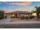 Beautiful single-story home featuring desert landscaping, a two-car garage, and a tile roof at sunset at 6993 S Roger Way, Chandler, AZ 85249