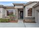 Inviting front entrance with stone accents, a decorative door, and well-maintained landscaping at 6993 S Roger Way, Chandler, AZ 85249