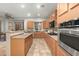 Bright kitchen featuring stainless steel appliances, wood cabinetry and tile flooring at 6993 S Roger Way, Chandler, AZ 85249