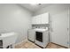 Well-lit laundry room with modern washer and dryer, sink, and ample storage space at 6993 S Roger Way, Chandler, AZ 85249