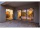 Covered patio with brick-paved flooring and large sliding glass doors offering a view of the home's interior at 6993 S Roger Way, Chandler, AZ 85249