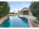 Inviting pool surrounded by lush landscaping, a fire pit, and a spacious patio area at 6993 S Roger Way, Chandler, AZ 85249