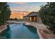 Backyard swimming pool with a brick paver deck, artificial turf, and mature landscaping at 6993 S Roger Way, Chandler, AZ 85249