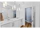 Contemporary bathroom with dual sinks, modern lighting, and stylish white cabinets at 7300 E Earll Dr # 3016, Scottsdale, AZ 85251