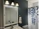 Nicely decorated bathroom featuring new white sink, framed mirror, and coordinated shower curtain at 7350 E Pueblo Ave, Mesa, AZ 85208