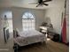 Bedroom features a charming bed, a vanity, and a faux brick wall, all bathed in natural light at 7350 E Pueblo Ave, Mesa, AZ 85208