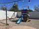 Fun backyard playground with slide, swings, climbing structure and string lights perfect for entertaining at 7350 E Pueblo Ave, Mesa, AZ 85208