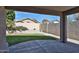 Inviting covered patio overlooking a well-maintained backyard with lush grass and block fencing at 7642 W Carlota Ln, Peoria, AZ 85383