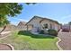 Beautiful backyard featuring green lawn, mature landscaping, and a private fenced yard at 7642 W Carlota Ln, Peoria, AZ 85383