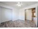 Bedroom with wood-look flooring, a ceiling fan, and a closet at 7642 W Carlota Ln, Peoria, AZ 85383