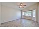 A spacious bedroom featuring wood-look tile flooring, a ceiling fan, and a bright bay window at 7642 W Carlota Ln, Peoria, AZ 85383