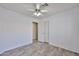 Bedroom with wood-look floors, a ceiling fan, and a sliding door closet at 7642 W Carlota Ln, Peoria, AZ 85383