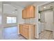 Hallway leading to the laundry room with built-in cabinets and tile flooring at 7642 W Carlota Ln, Peoria, AZ 85383