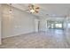 Open living room showcasing wood-look tile, neutral walls, and an airy ceiling at 7642 W Carlota Ln, Peoria, AZ 85383