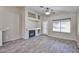 Comfortable living room featuring a fireplace, built-in shelves, and a glass door at 7642 W Carlota Ln, Peoria, AZ 85383