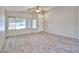 Bright living room featuring wood-look tile flooring, large windows, and a ceiling fan at 7642 W Carlota Ln, Peoria, AZ 85383