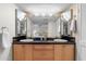 Beautiful bathroom featuring double sinks, ample lighting, and well-maintained cabinets at 7912 E Plaza Ave, Scottsdale, AZ 85250