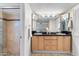 Bathroom showcasing double sinks, a large mirror, and a full glass-enclosed shower at 7912 E Plaza Ave, Scottsdale, AZ 85250