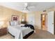 Comfortable bedroom with a ceiling fan, a brick accent wall and an ensuite bathroom at 7912 E Plaza Ave, Scottsdale, AZ 85250