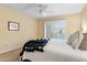 Comfortable bedroom with shuttered windows and a neutral color scheme at 7912 E Plaza Ave, Scottsdale, AZ 85250