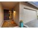 Inviting home entrance with security screen door, leading to an attached garage and desert landscaping at 7912 E Plaza Ave, Scottsdale, AZ 85250