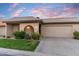 Inviting single-story home featuring a well-manicured lawn, desert landscaping, and a two-car garage at 7912 E Plaza Ave, Scottsdale, AZ 85250