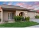 Charming single-story home featuring an arched entryway, attached garage, and manicured landscaping at 7912 E Plaza Ave, Scottsdale, AZ 85250