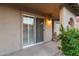 Covered patio with sliding glass doors and lush landscaping at 7912 E Plaza Ave, Scottsdale, AZ 85250