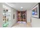 Welcoming foyer with tiled floors, art on display, and double doors leading outside at 7912 E Plaza Ave, Scottsdale, AZ 85250