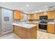 Bright kitchen featuring wood cabinets, stainless appliances and a large island with white countertop at 7912 E Plaza Ave, Scottsdale, AZ 85250