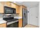 This kitchen features stainless steel appliances, wood cabinets and a light countertop at 7912 E Plaza Ave, Scottsdale, AZ 85250