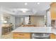 Bright kitchen featuring wood cabinets, stainless appliances and an adjacent dining area at 7912 E Plaza Ave, Scottsdale, AZ 85250