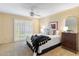 Lovely bedroom with accent wall, ceiling fan and plantation shutters on the windows at 7912 E Plaza Ave, Scottsdale, AZ 85250